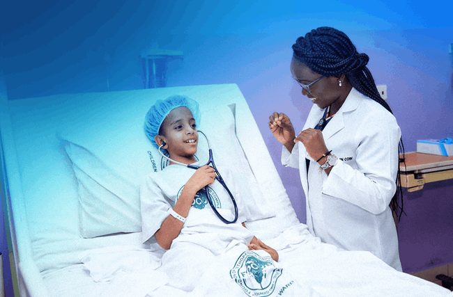 Female doctor wearing white coat having conversation with child in hospital bed.